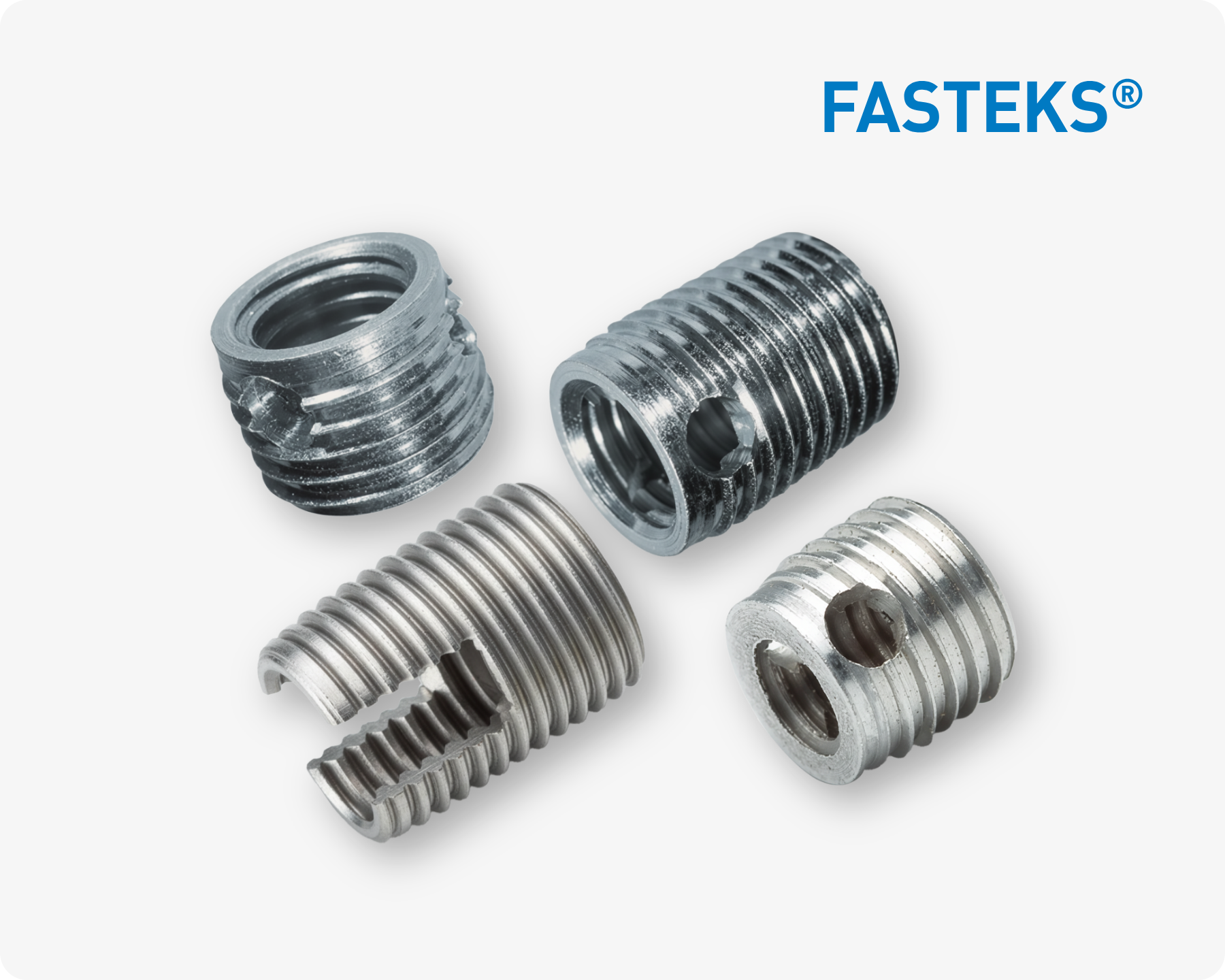 Quattro inserti filettati metallici FASTEKS argentati di diverse forme su sfondo bianco con logo FASTEKS.