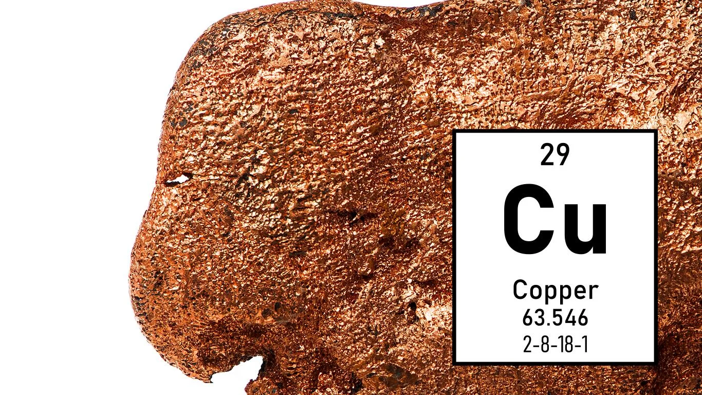 Reddish-metallic, shiny elemental copper with data from the periodic table.