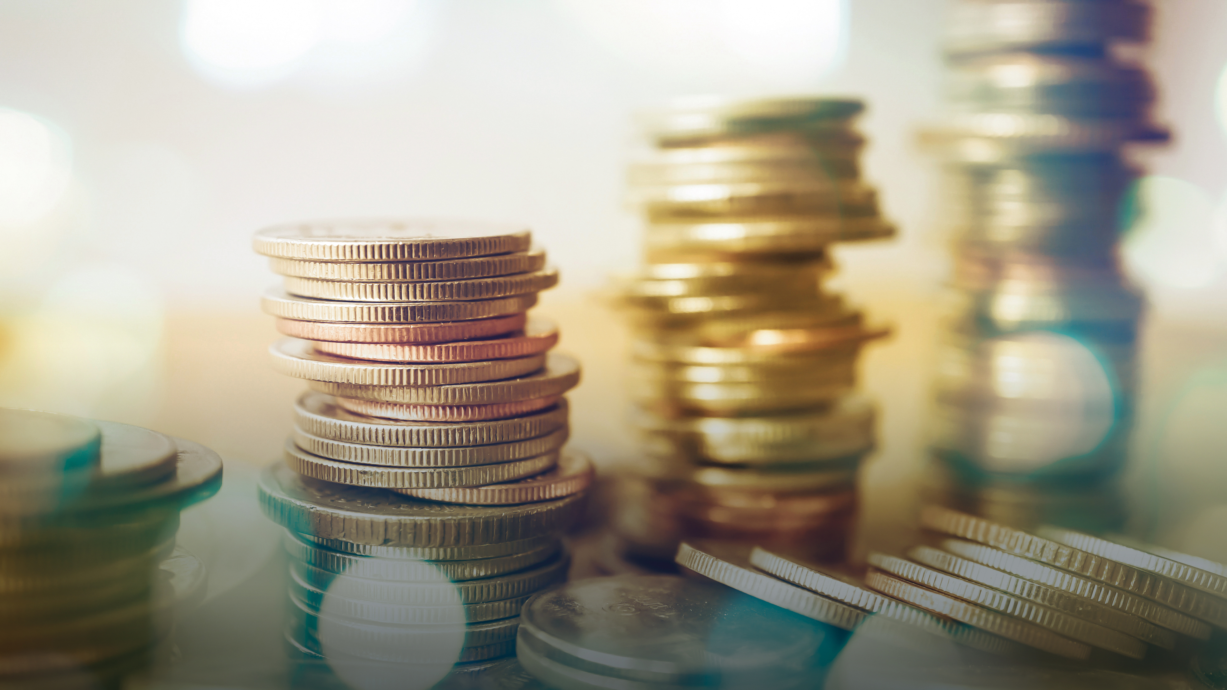 A close-up of several coins stacked into 4 towers