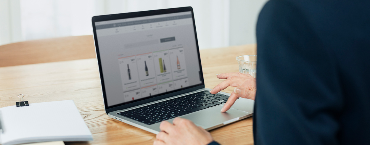 Close-up of a woman on a laptop with Alko's ecommerce pages on the screen.