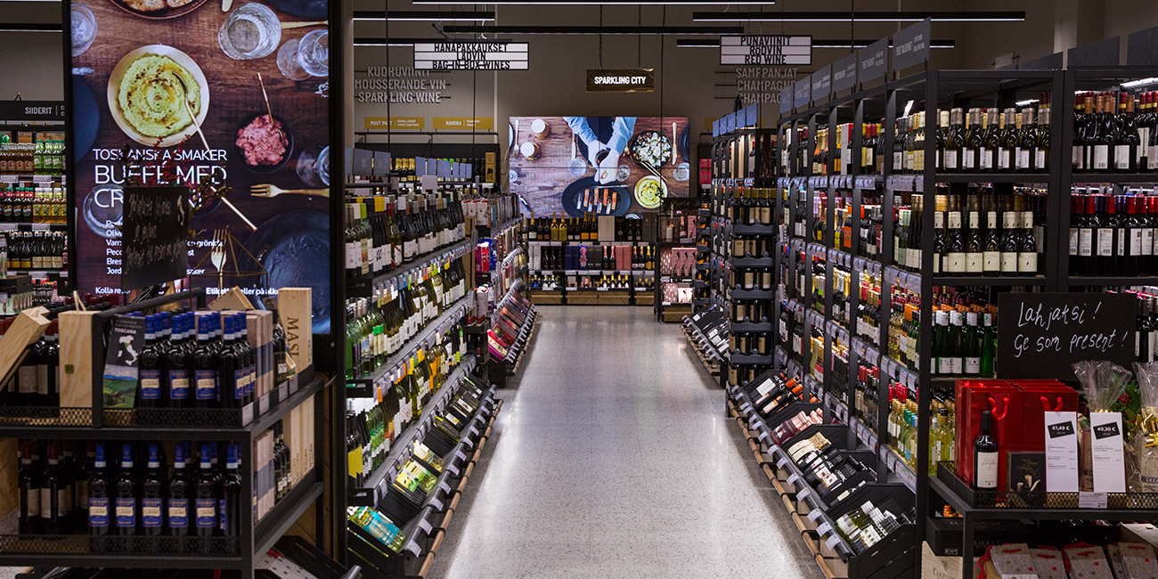An Alko store with plenty of shelves full of different products.