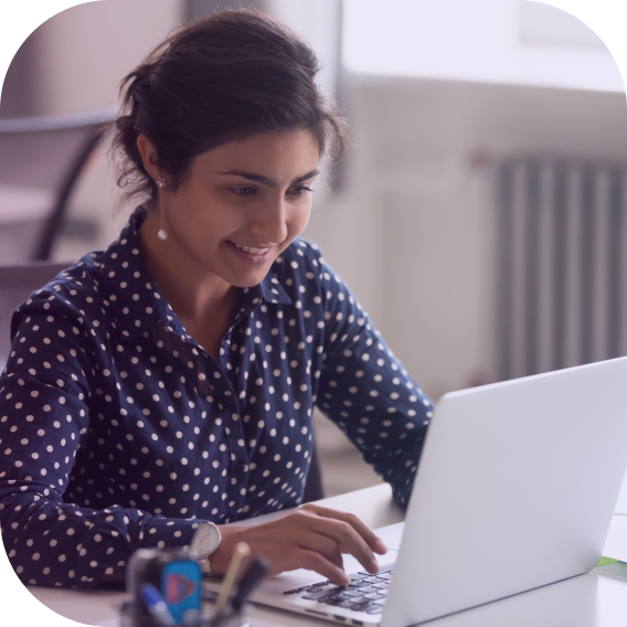 woman at desk using laptop