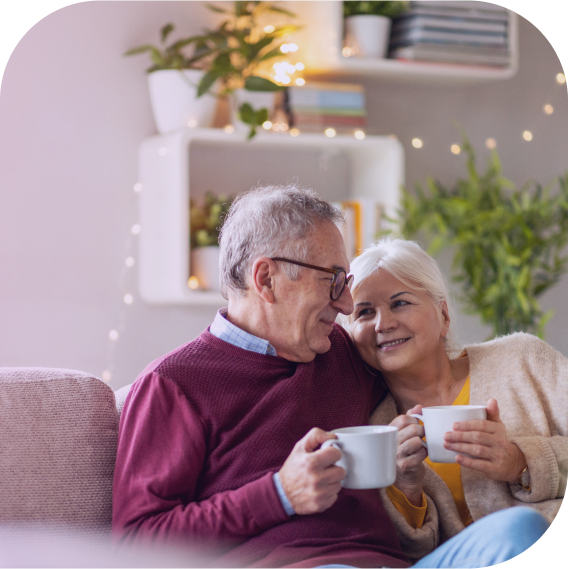 older couple on sofa with tea