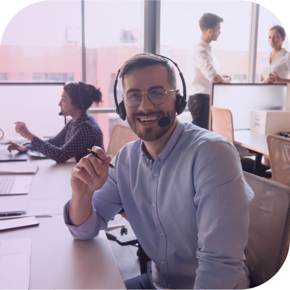smiling man wearing headset in office
