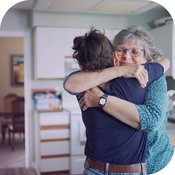 woman hugs older woman
