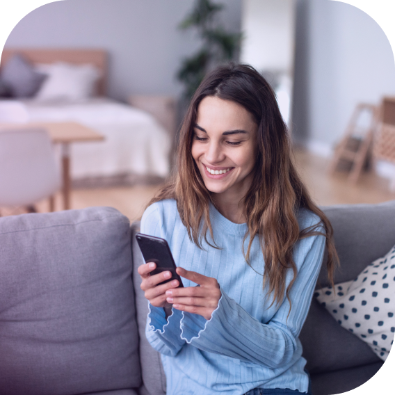 woman on sofa holding phone