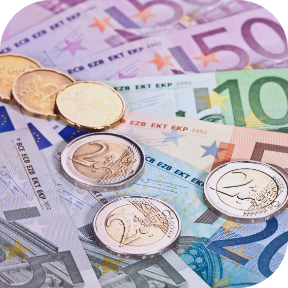 euro notes fanned with coins on top