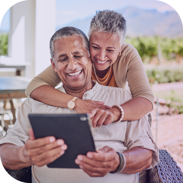 couple on tablet seated hug