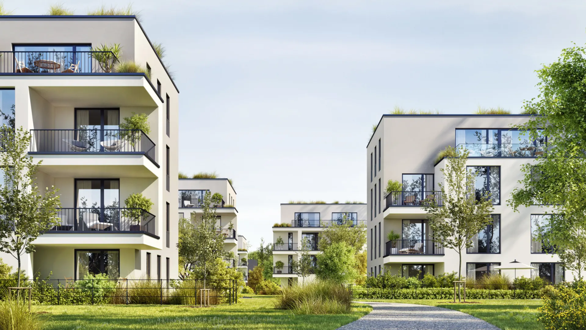 Smart City GmbH - Unser Zuhause, unsere Zukunft. (Foto: iStock) Moderne Wohnanlage mit mehrstöckigen Gebäuden in zeitgenössischer Architektur. Die hellen Fassaden mit großen Fenstern und Balkonen fügen sich harmonisch in eine grüne Parklandschaft ein.