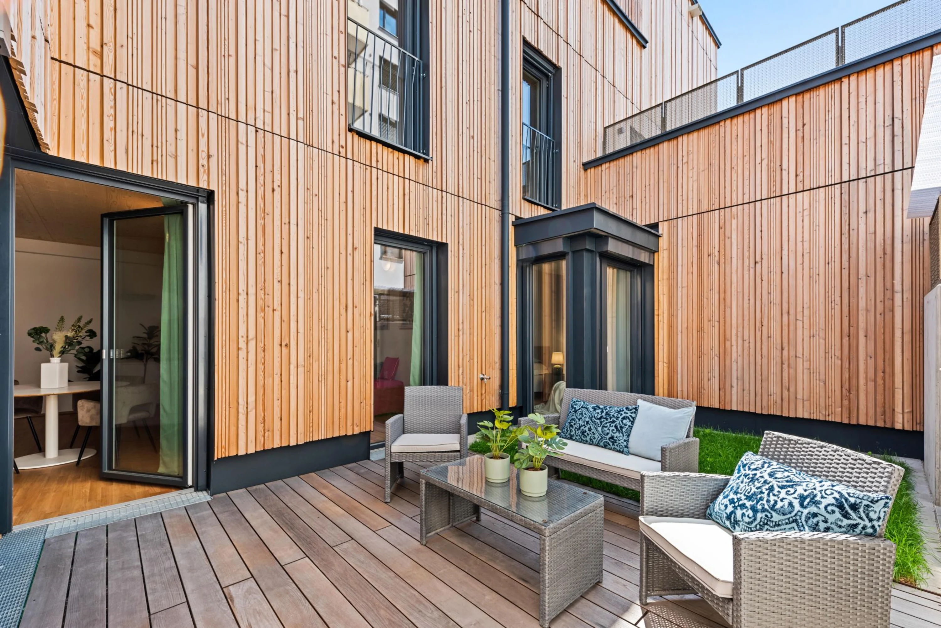 Image: Three-storey wood hybrid residential building with garden and terrace.