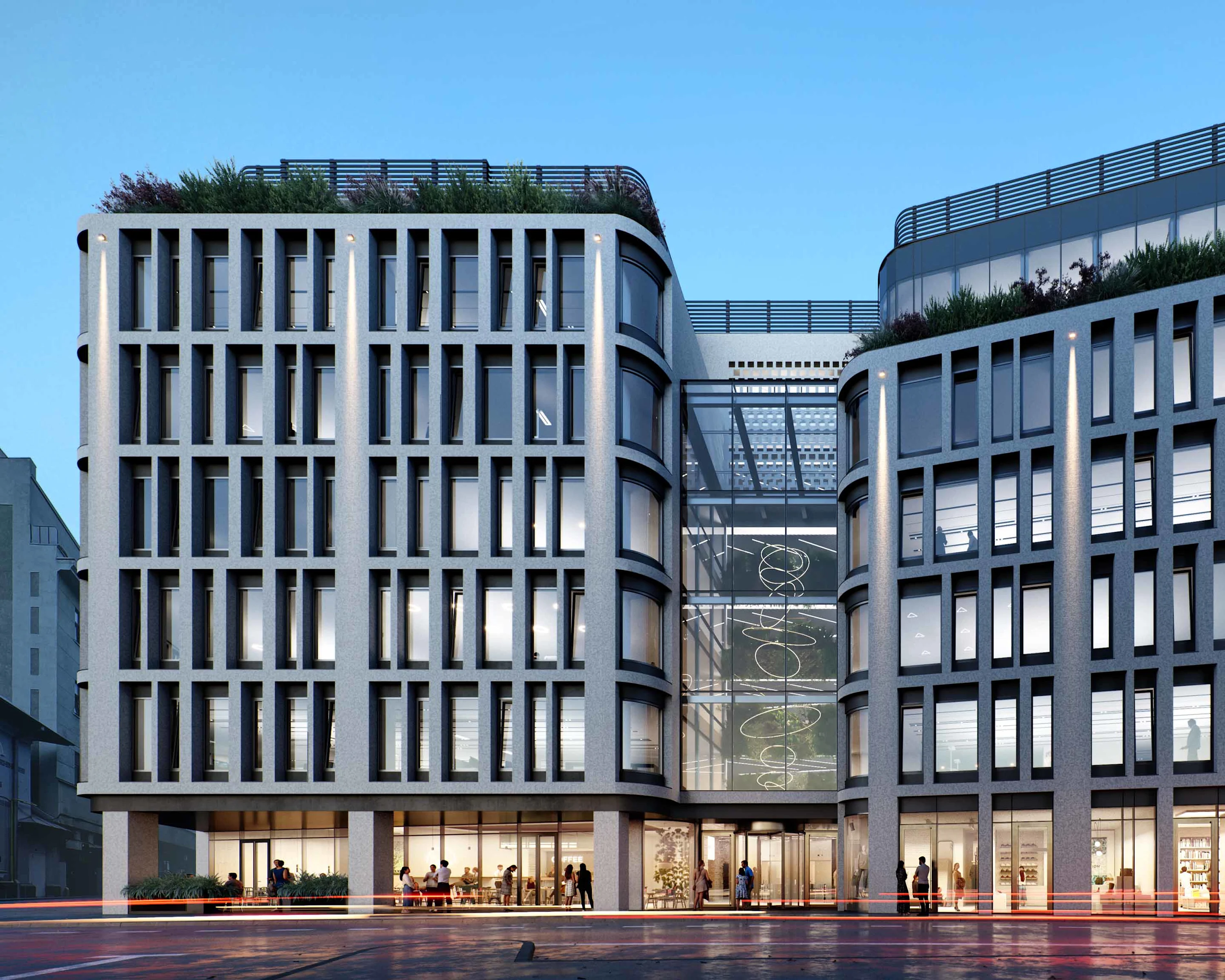 Foto: Fasáda novej administratívnej budovy žiari vo večernej atmosfére.