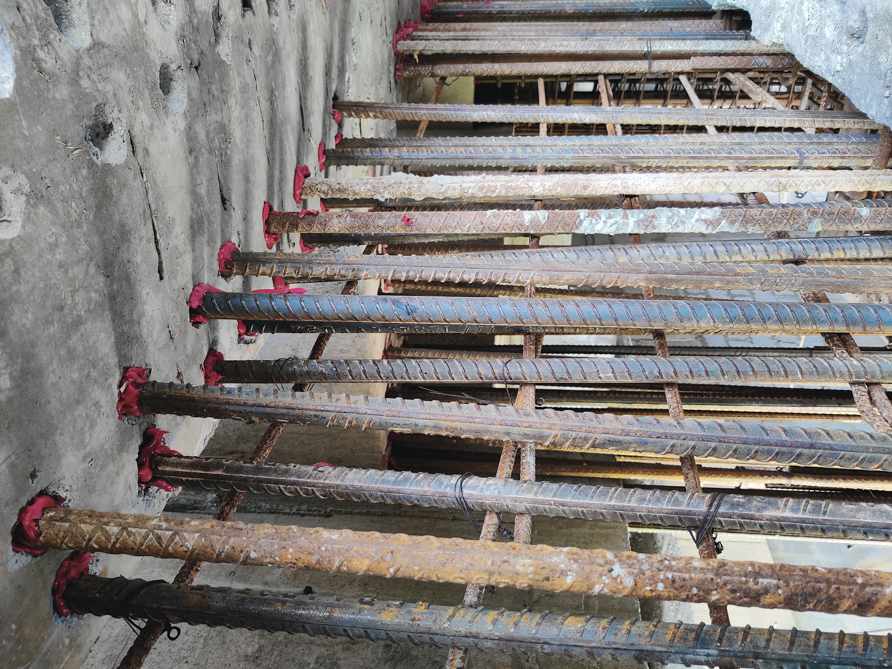 Concrete structural wall to slab soffit connection using pos-installed rebar