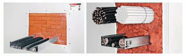 Firestop penetration system sealing cable trays and electrical services passing through a fire-rated wall, with orange firestop material filling the opening around the penetrations.