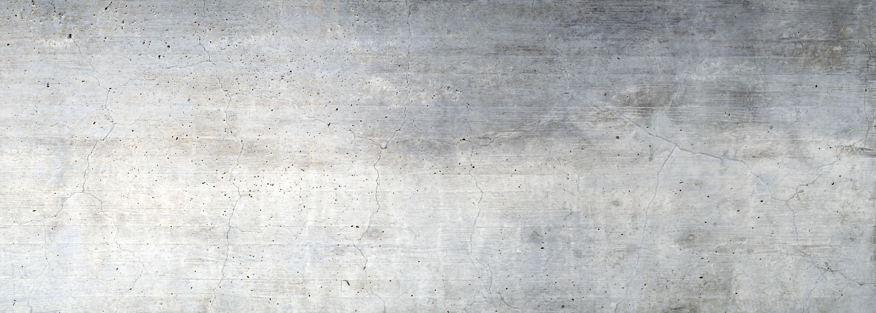 Light gray concrete surface with subtle texture, faint stains, and small cracks, forming a neutral industrial background.