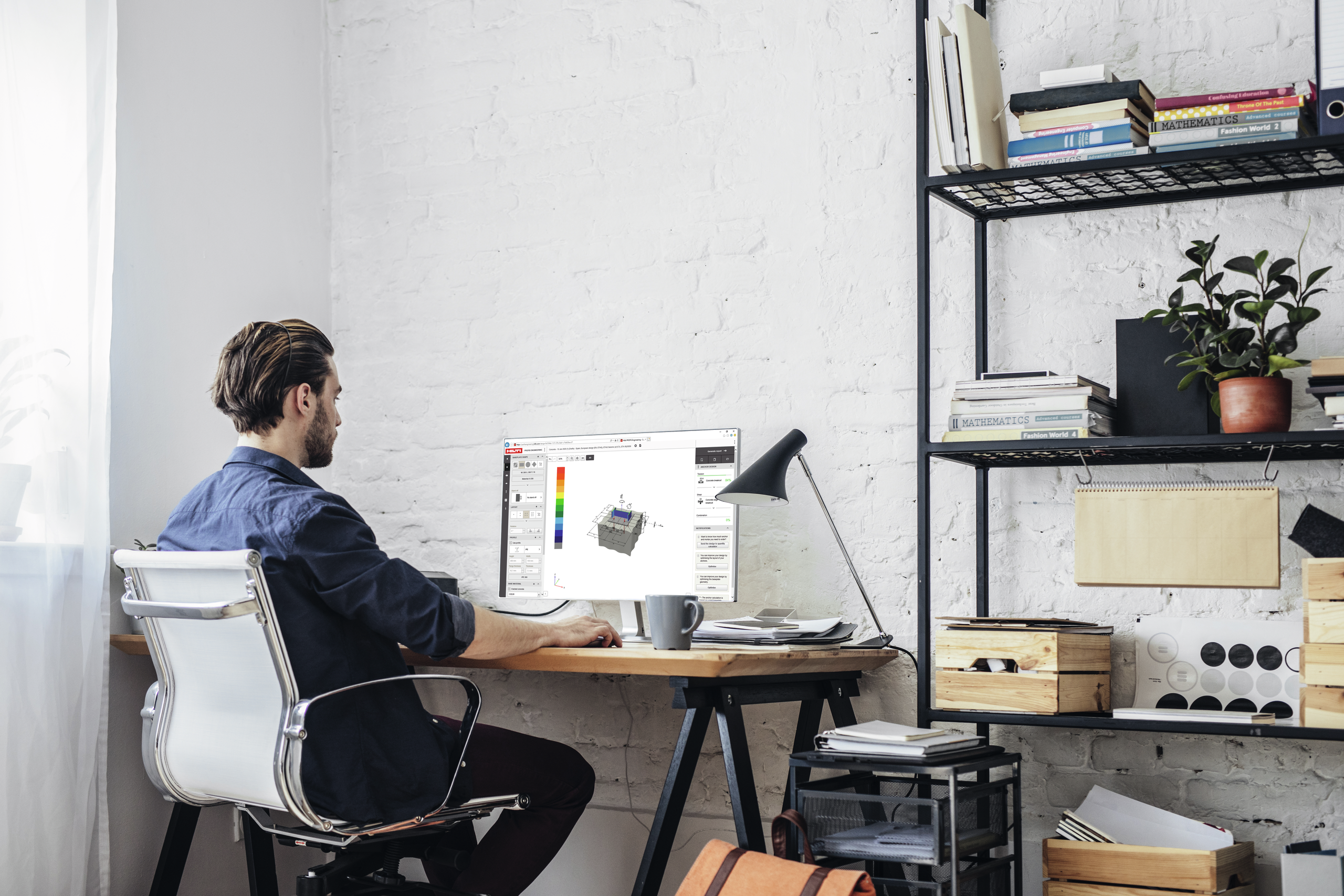 Man at computer desk looking at PROFIS software on his screen