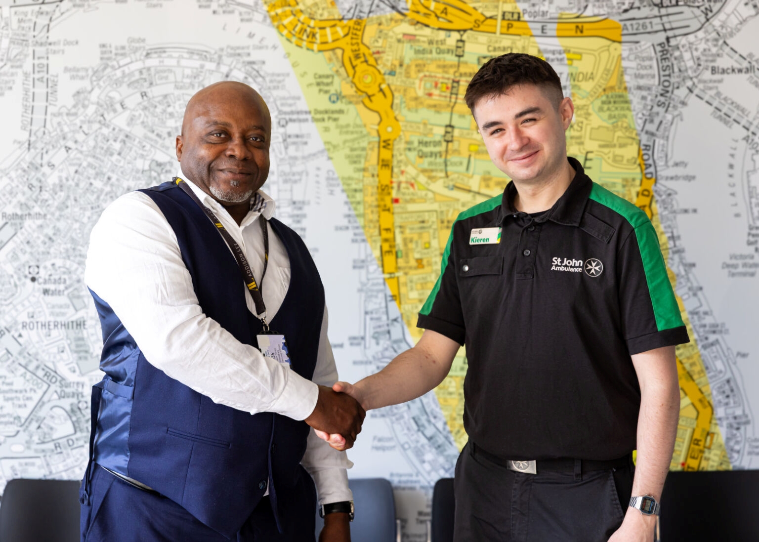 Hero driver Godwin Omotobora, shaking hands with a St John Ambulance trainer.