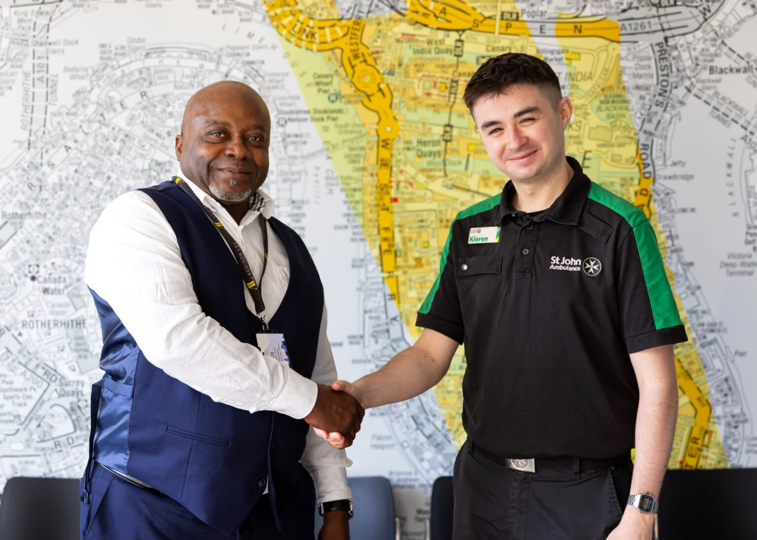 Hero driver Godwin Omotobora, shaking hands with a St John Ambulance trainer.