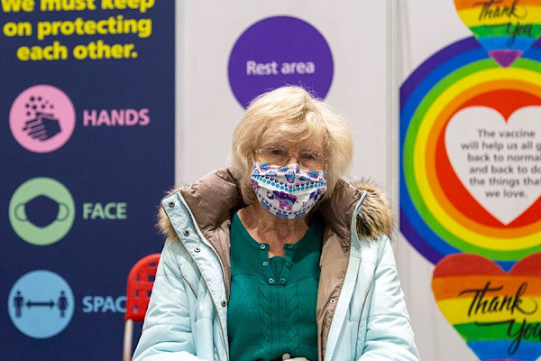 A photograph of Doris wearing a cloth face mask.