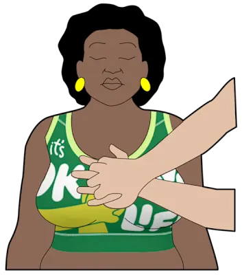 An illustration showing the correct hand placement for chest compressions. The first aider's fingers are interlocked and the heel of their hand is placed in the middle of the patient's chest. The patient is wearing a St John Ambulance CPR Bra, with the words 'It's okay to save my life' printed on it.