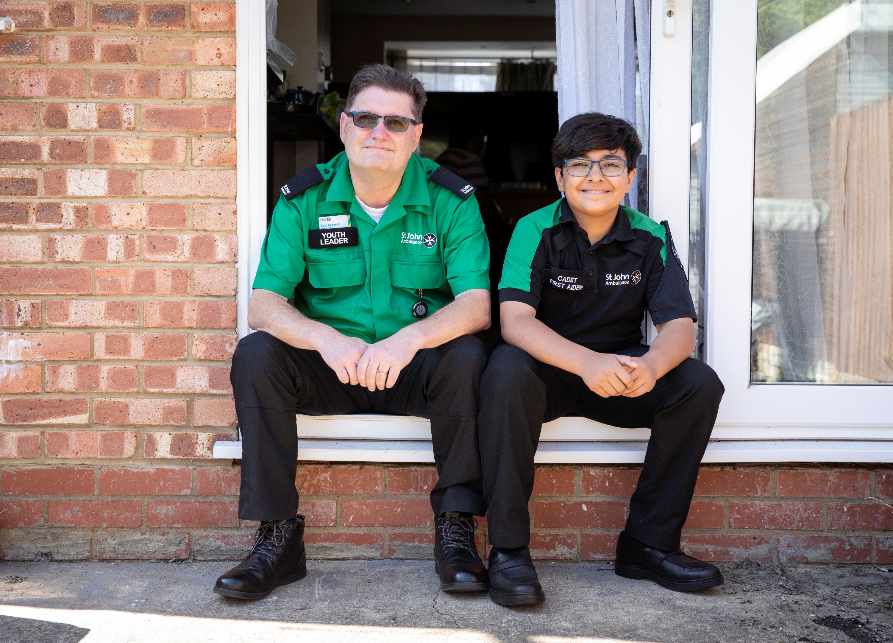 Maitham and Tom sat down wearing their St John Ambulance uniforms.