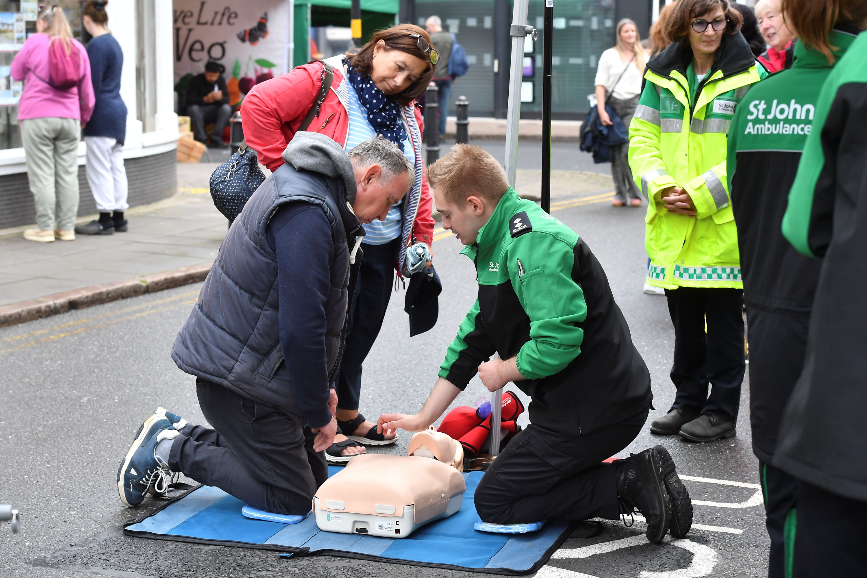 St John Ambulance volunteers giving passers-by a free community first aid session on the street.