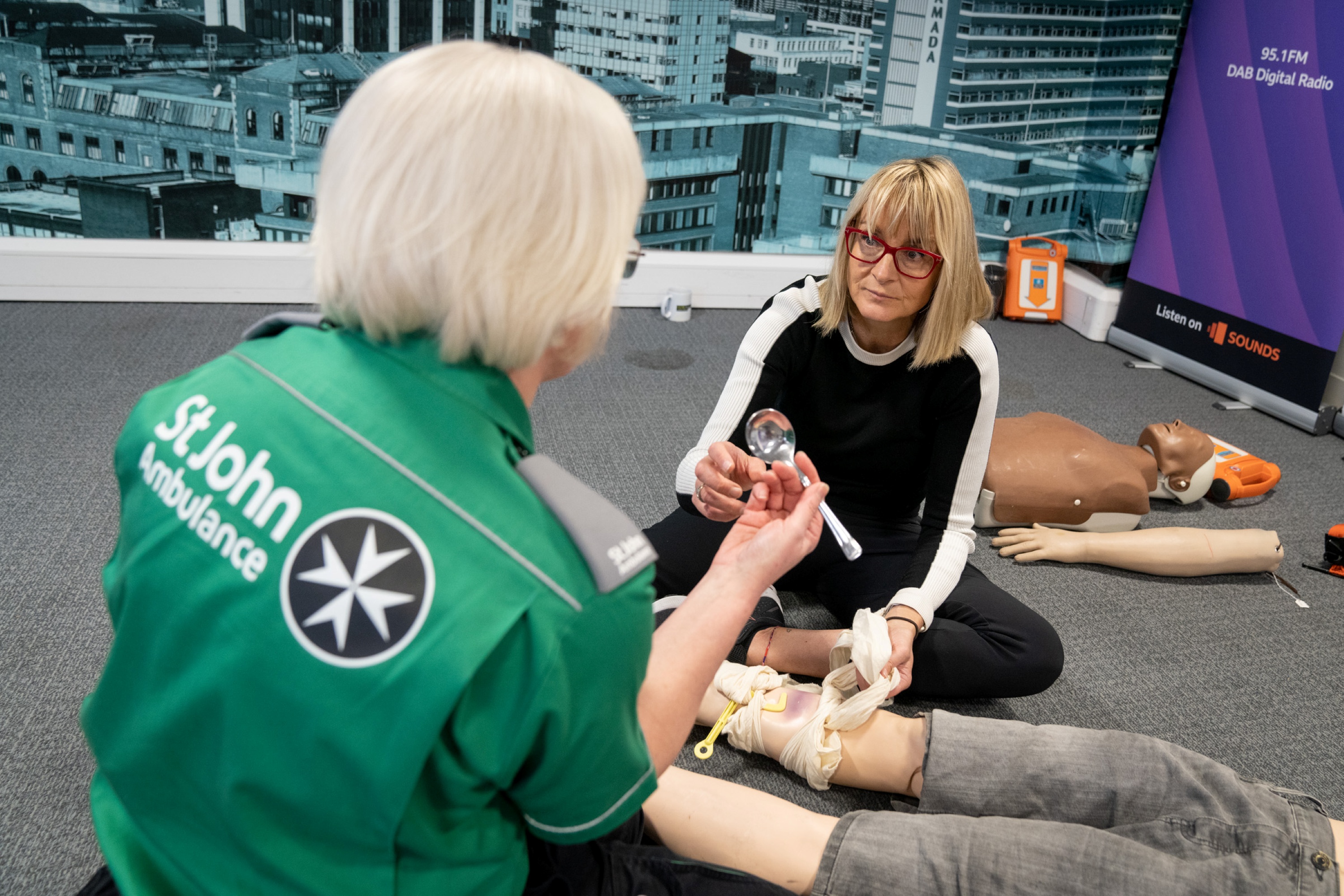 A St John Ambulance trainer giving a demonstration.