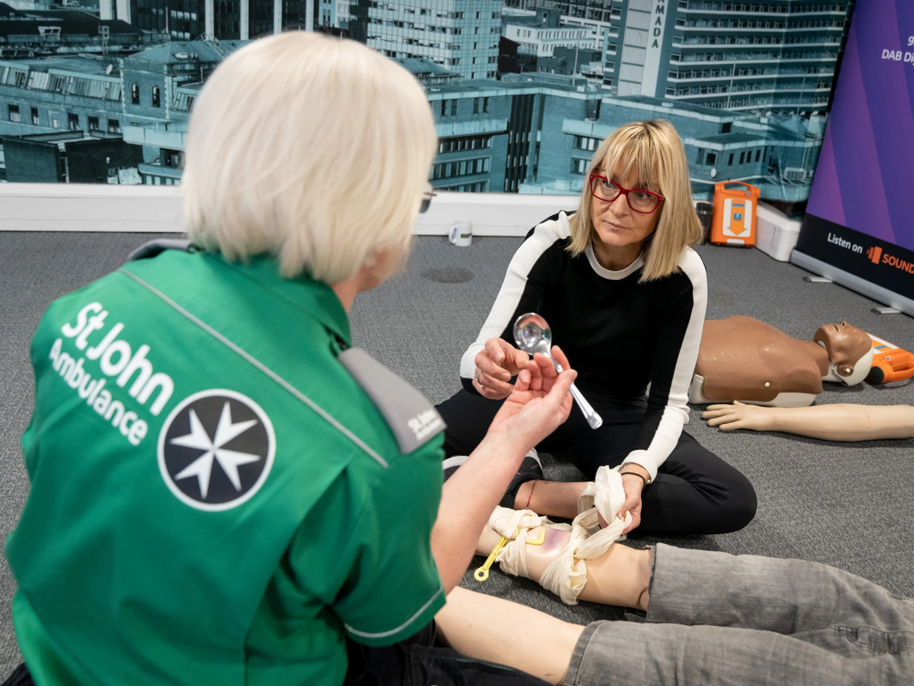 A St John Ambulance trainer giving a demonstration.