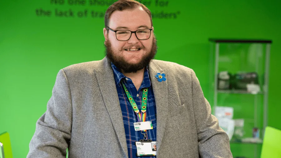 A photograph of Ross Comer smiling to camera.