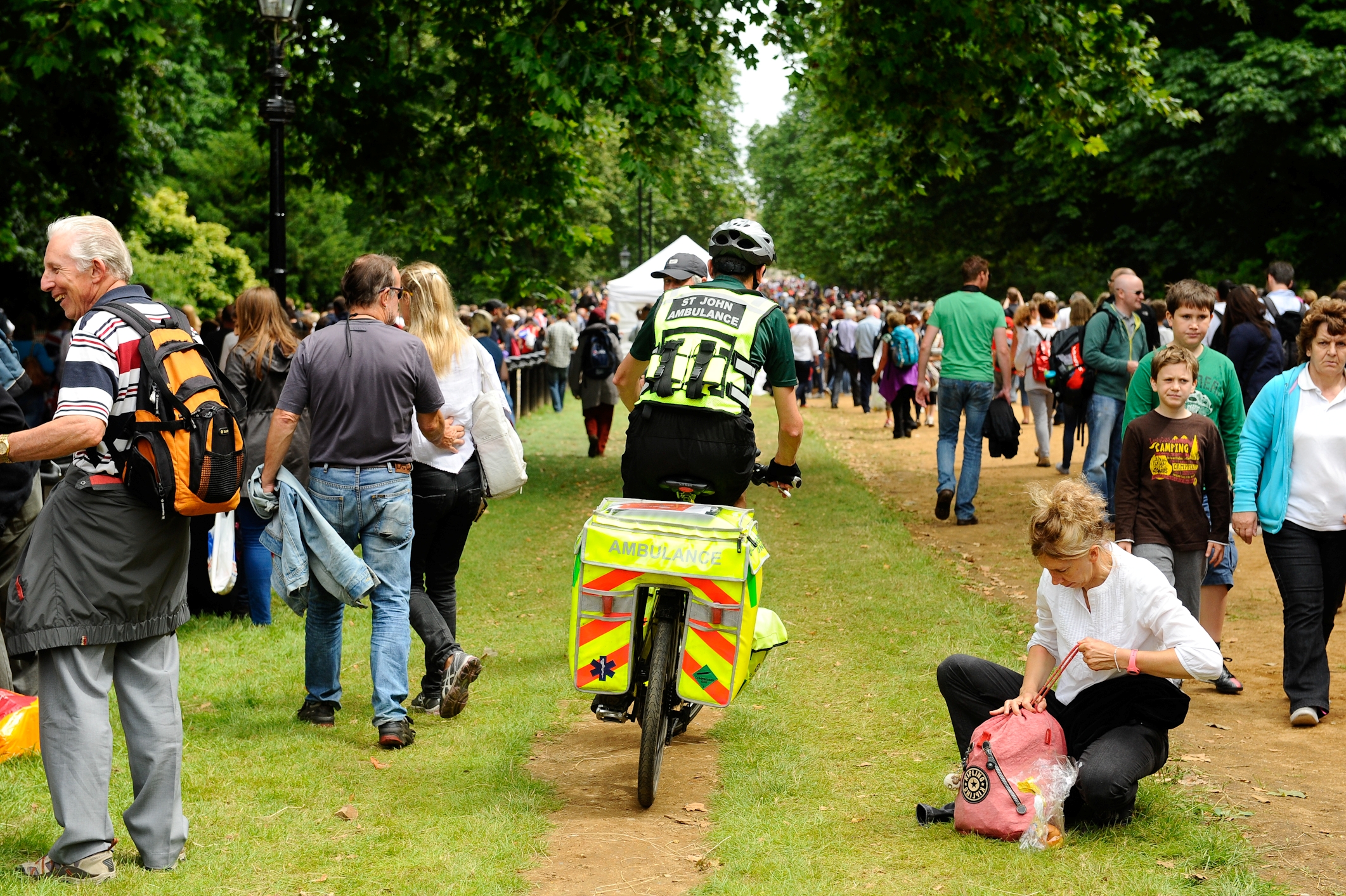 Cycle Responders riding through a crowd of people to get to someone in need of first aid.