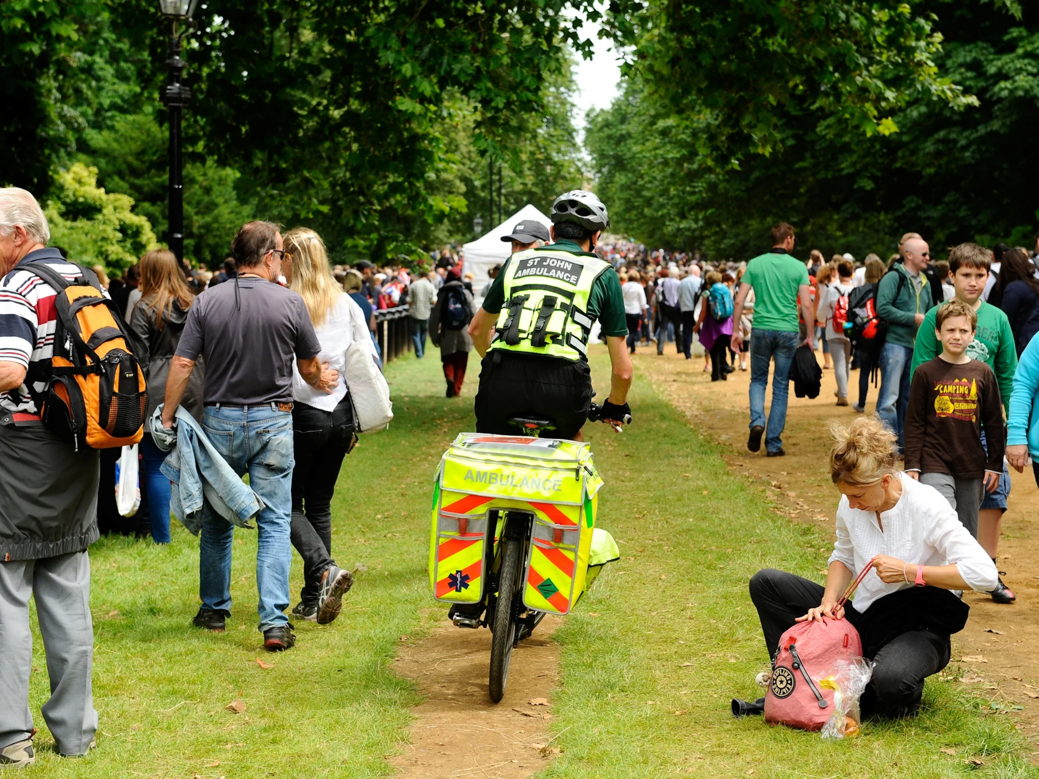 Cycle Responders riding through a crowd of people to get to someone in need of first aid.