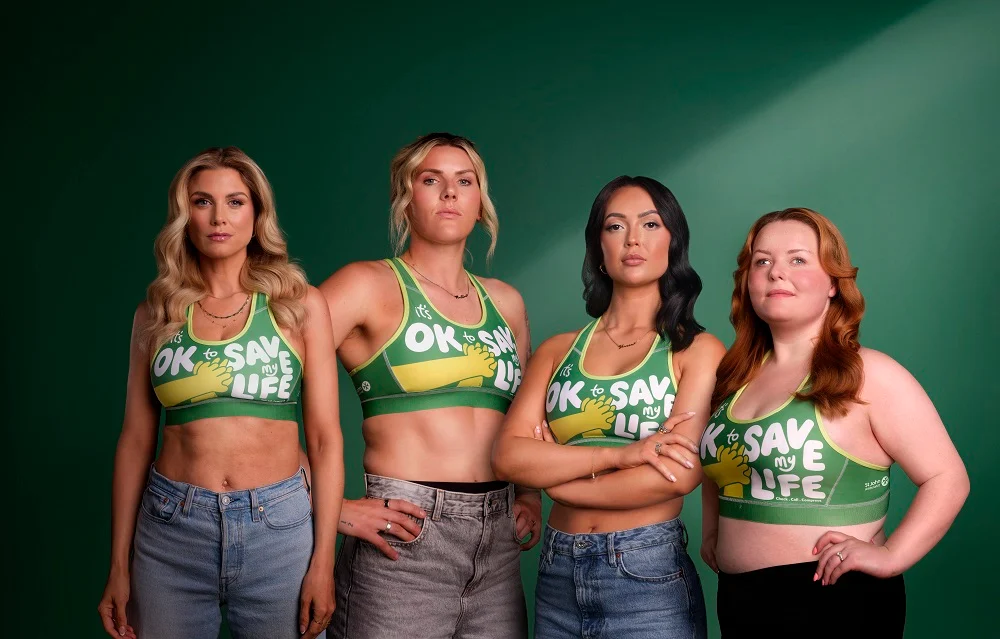 The CPR Bra teaming showing off the bra.