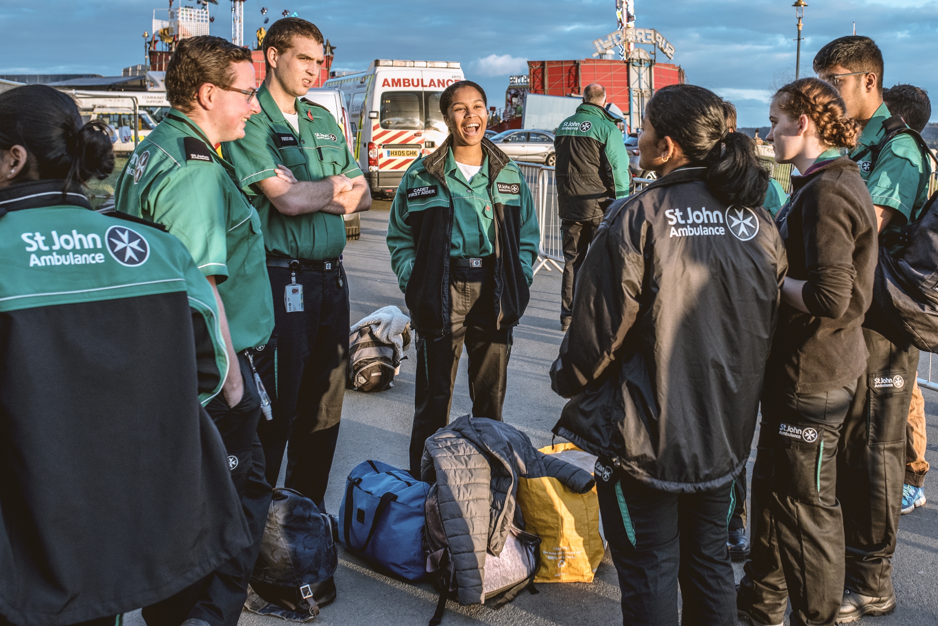 A photograph of Mary standing outside and laughing with a group of other St John Ambulance Cadets and volunteers.