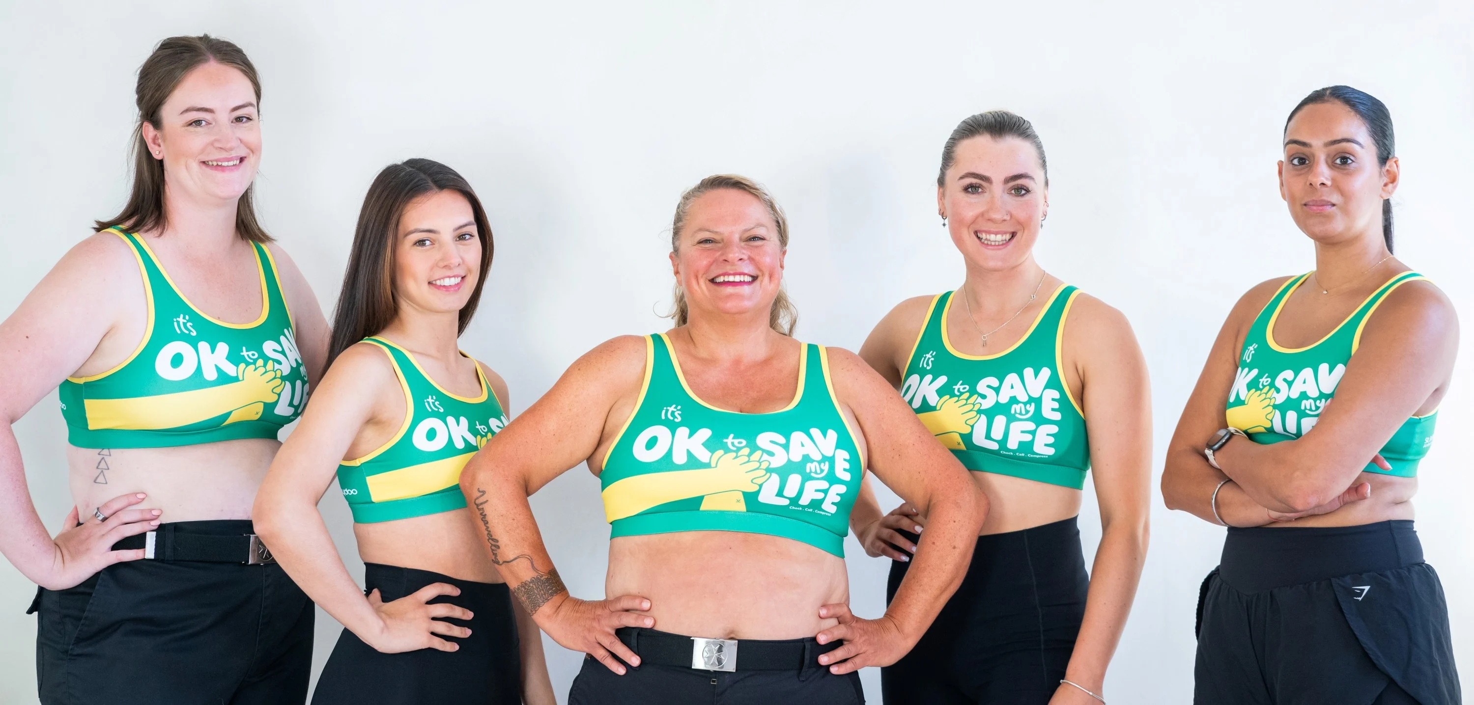 Five women standing in a row wearing the CPR Bra. 