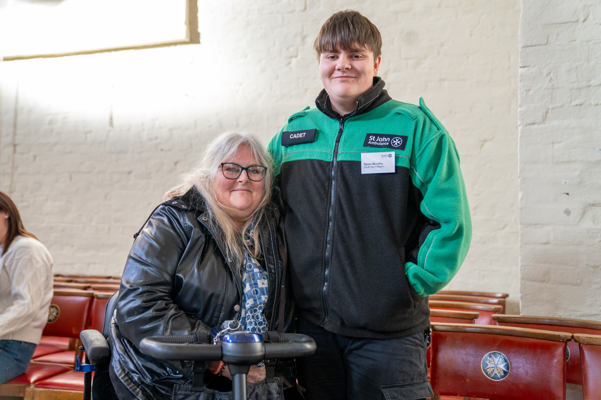 A photograph of Dylan and his mum. Dylan's wearing his St John uniform.