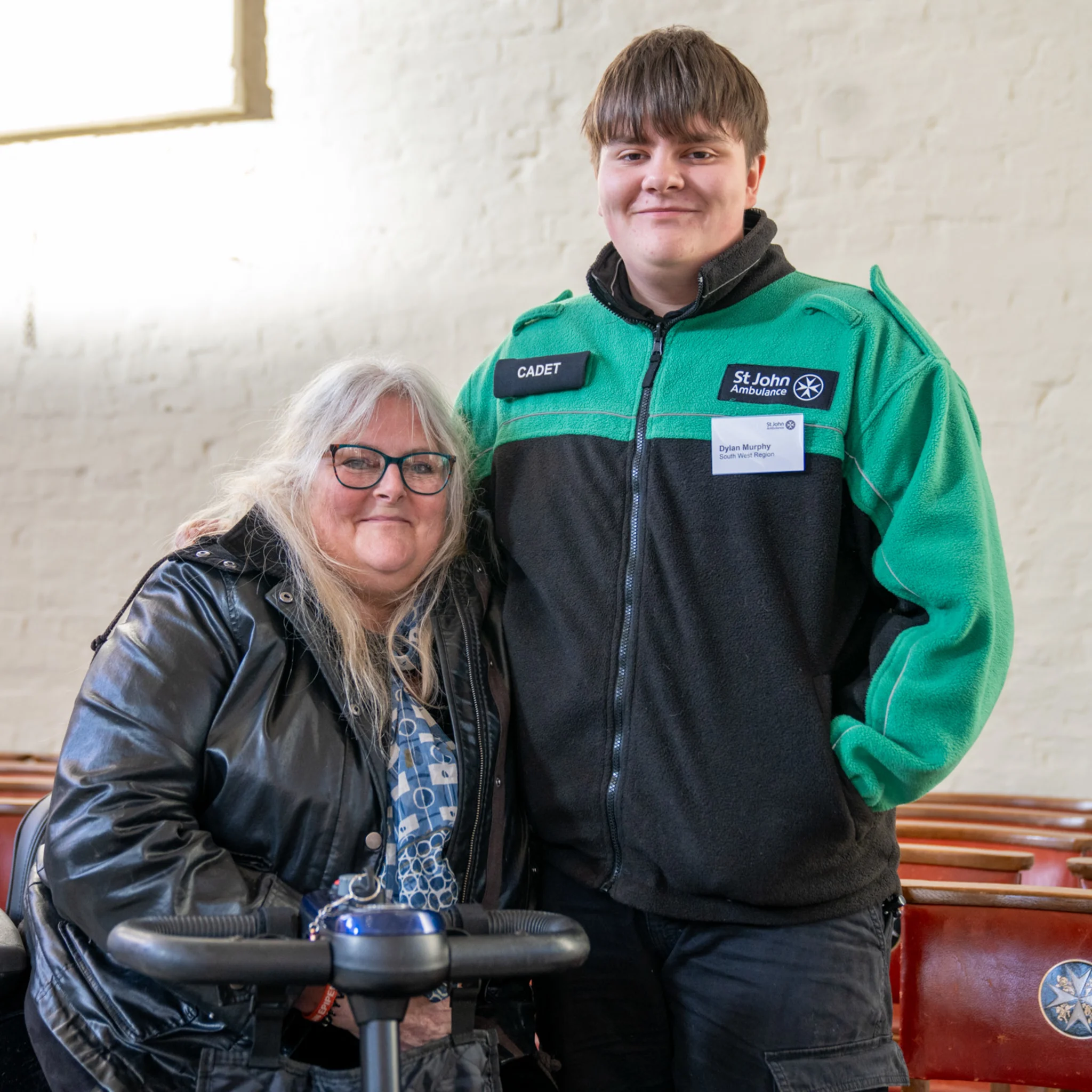 A photograph of Dylan and his mum. Dylan's wearing his St John uniform.