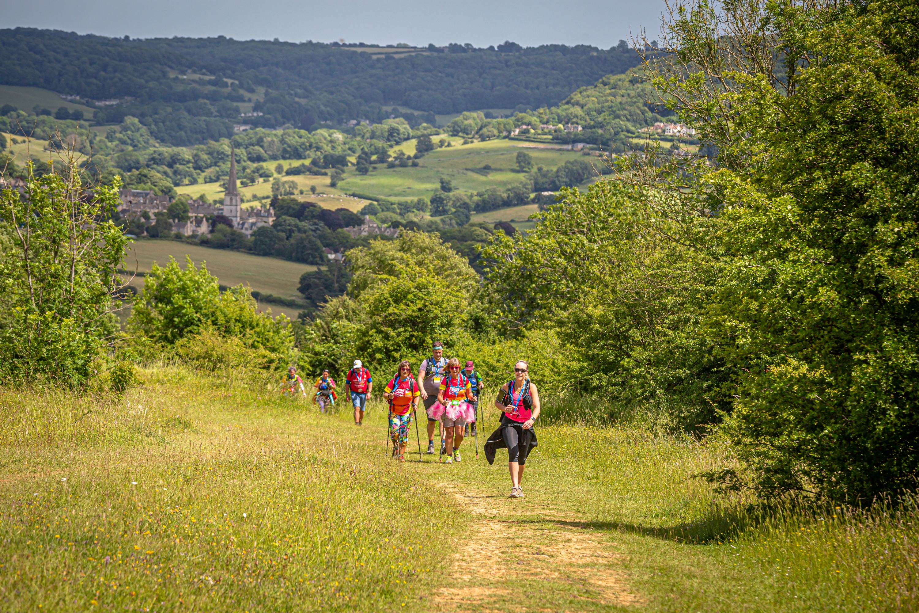 A small group of people walking on a trail through some of the Chilterns finest countryside.