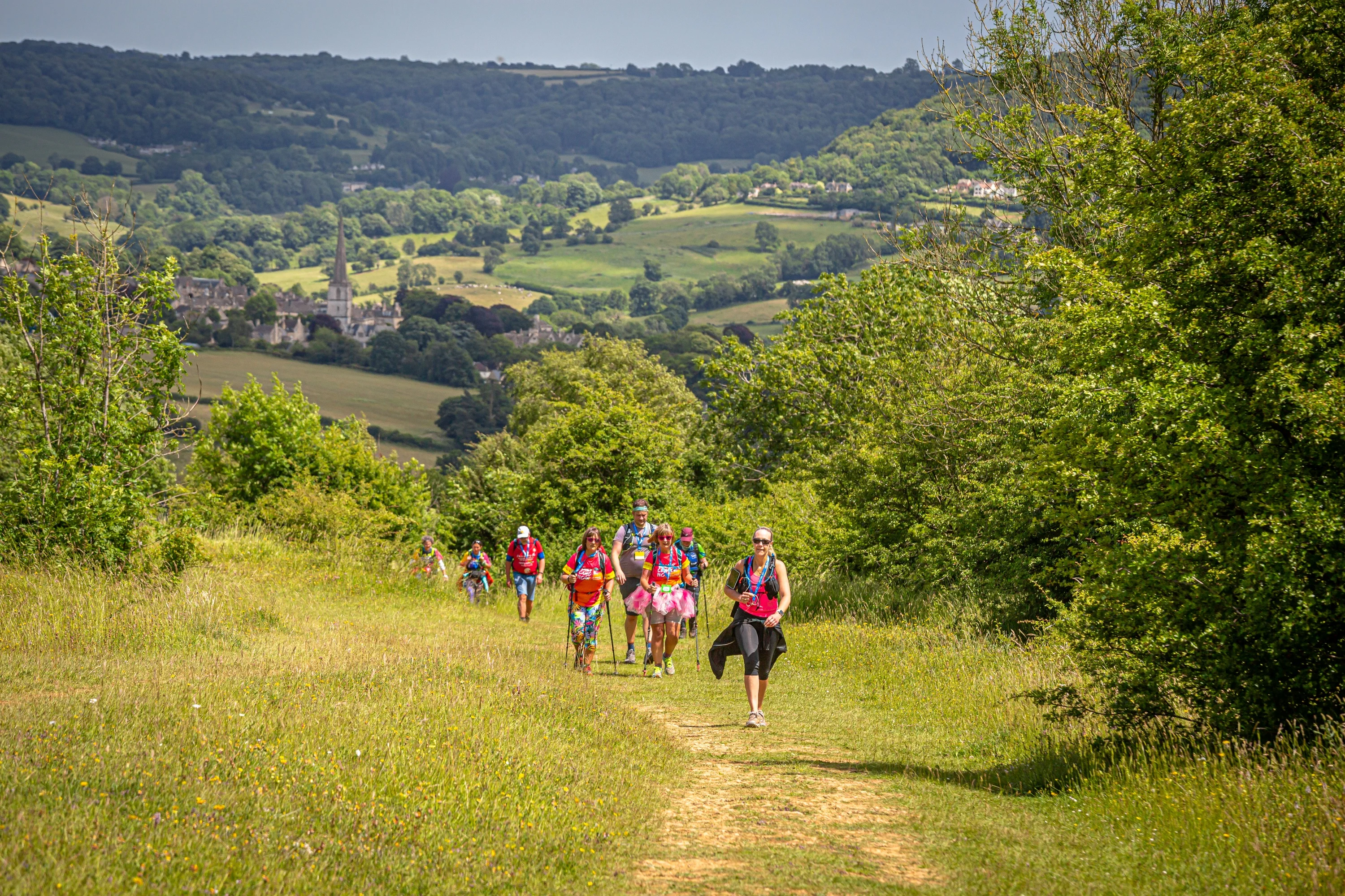 A small group of people walking on a trail through some of the Chilterns finest countryside.