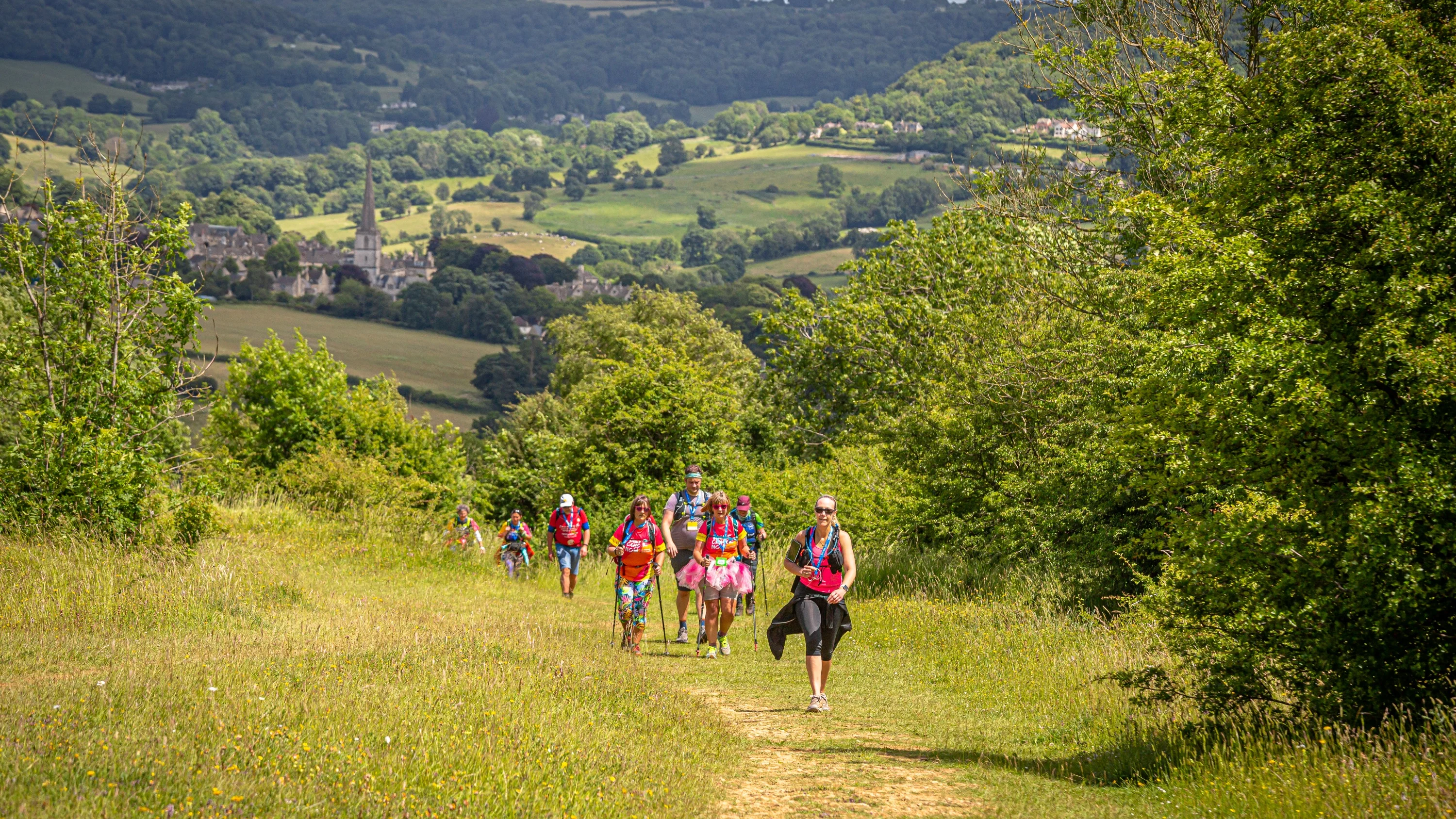 A small group of people walking on a trail through some of the Chilterns finest countryside.