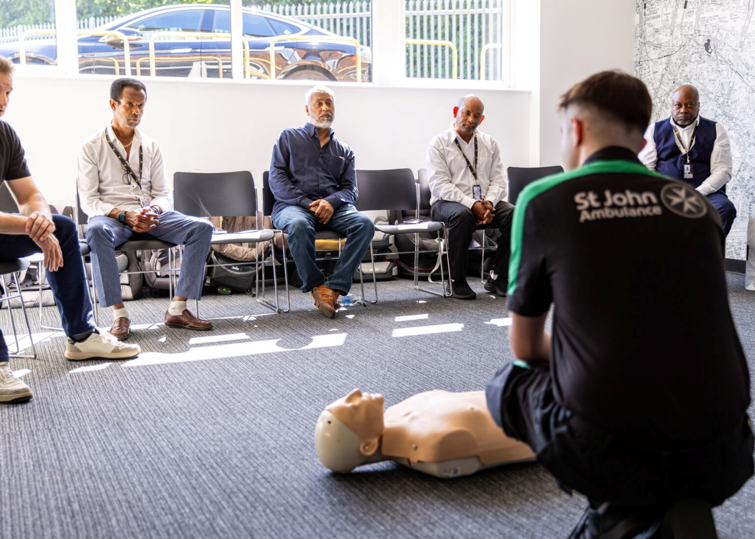 A St John Ambulance trainer delivering CPR and defibrillator sessions to Addison Lee drivers.