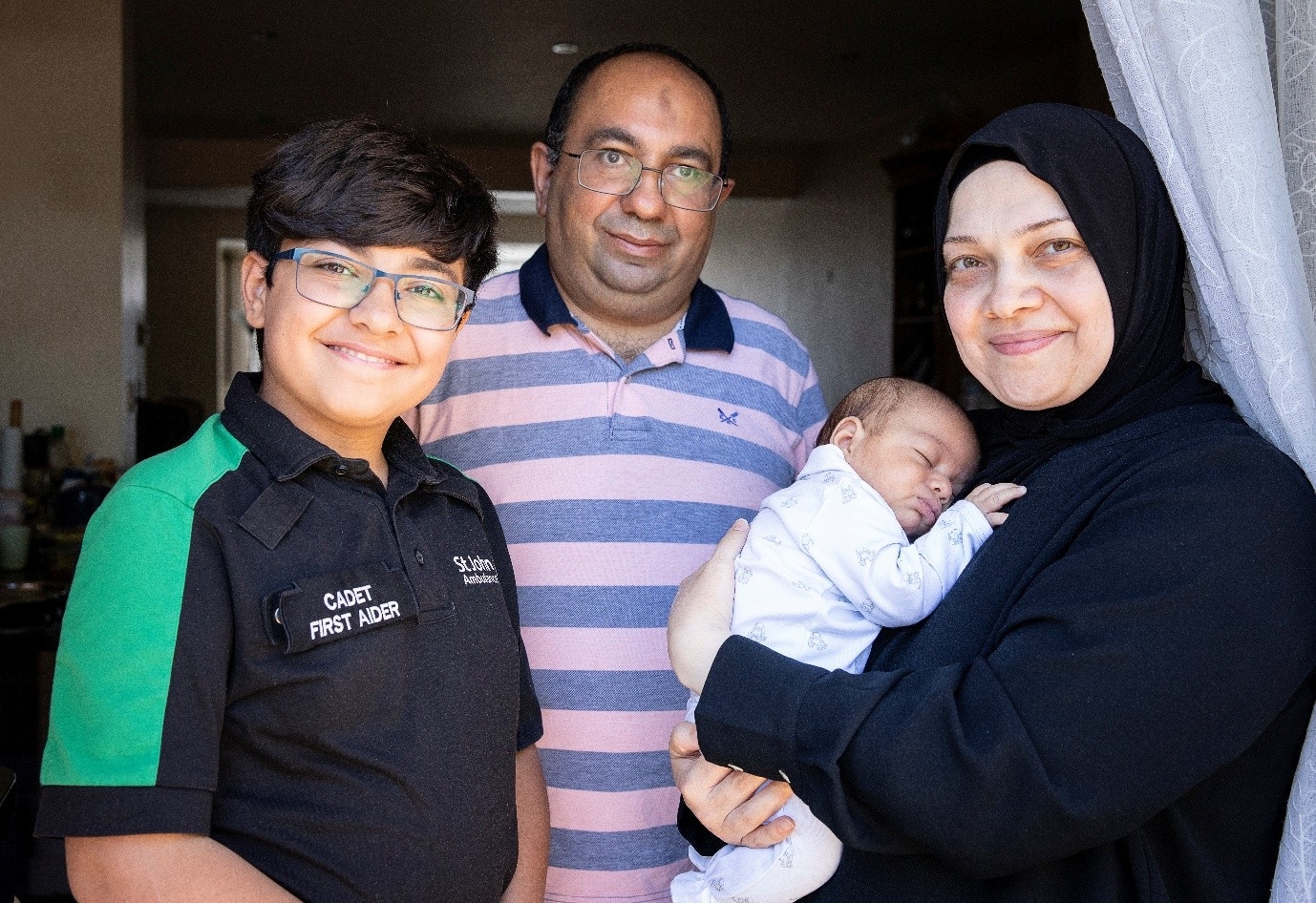 A photograph of Maitham with his mother, father, and baby brother, whose life he saved.