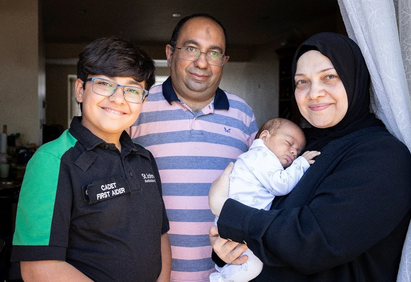 A photograph of Maitham with his mother, father, and baby brother, whose life he saved.