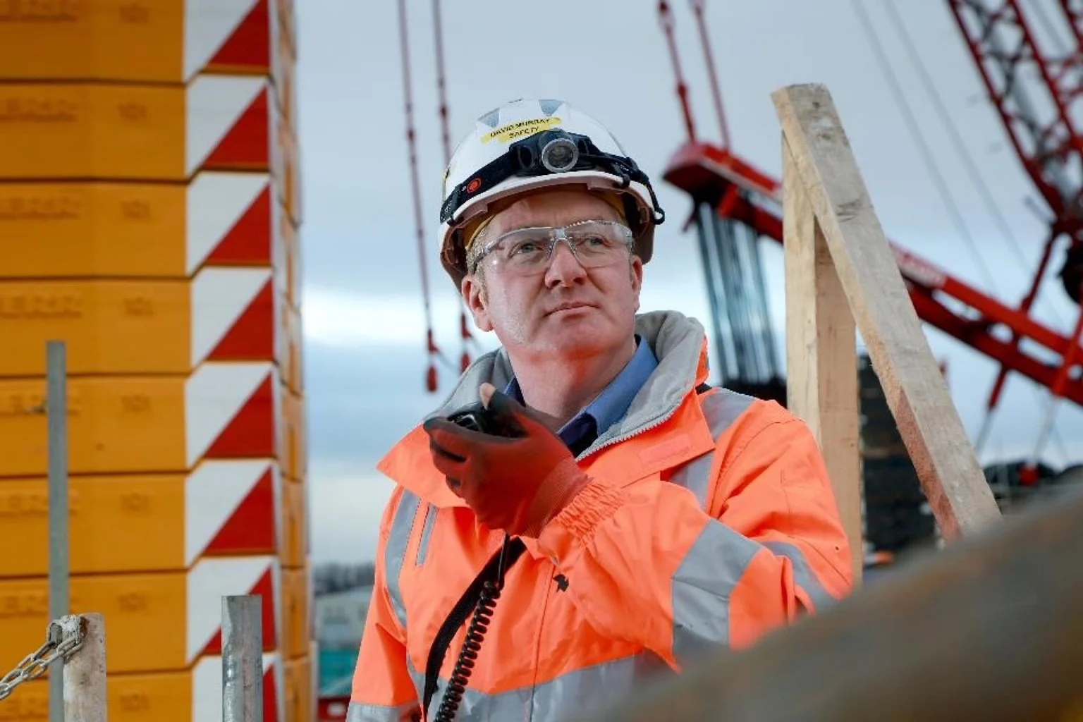 A photograph of David Murray on a construction site wearing his health and safety gear.