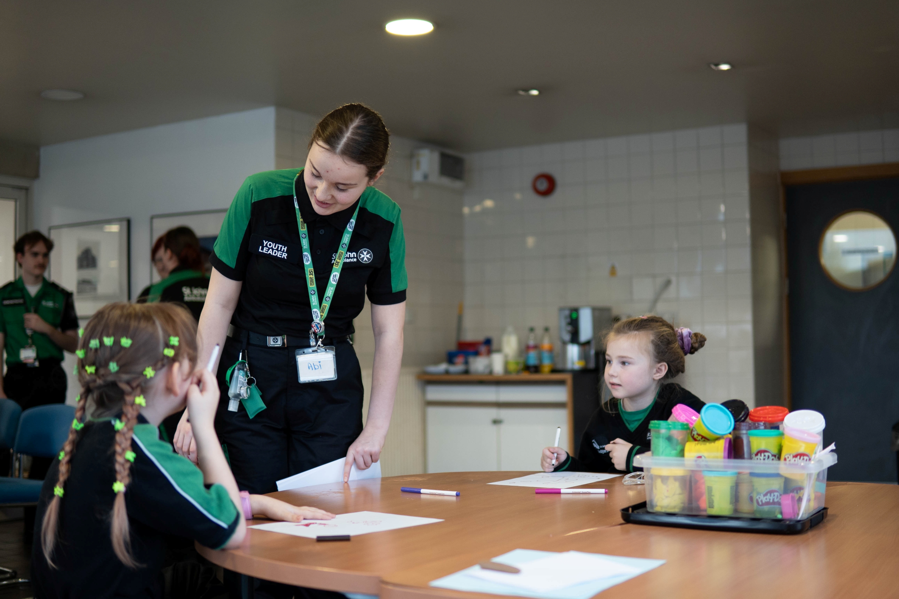 A St John Ambulance youth leader working with children.
