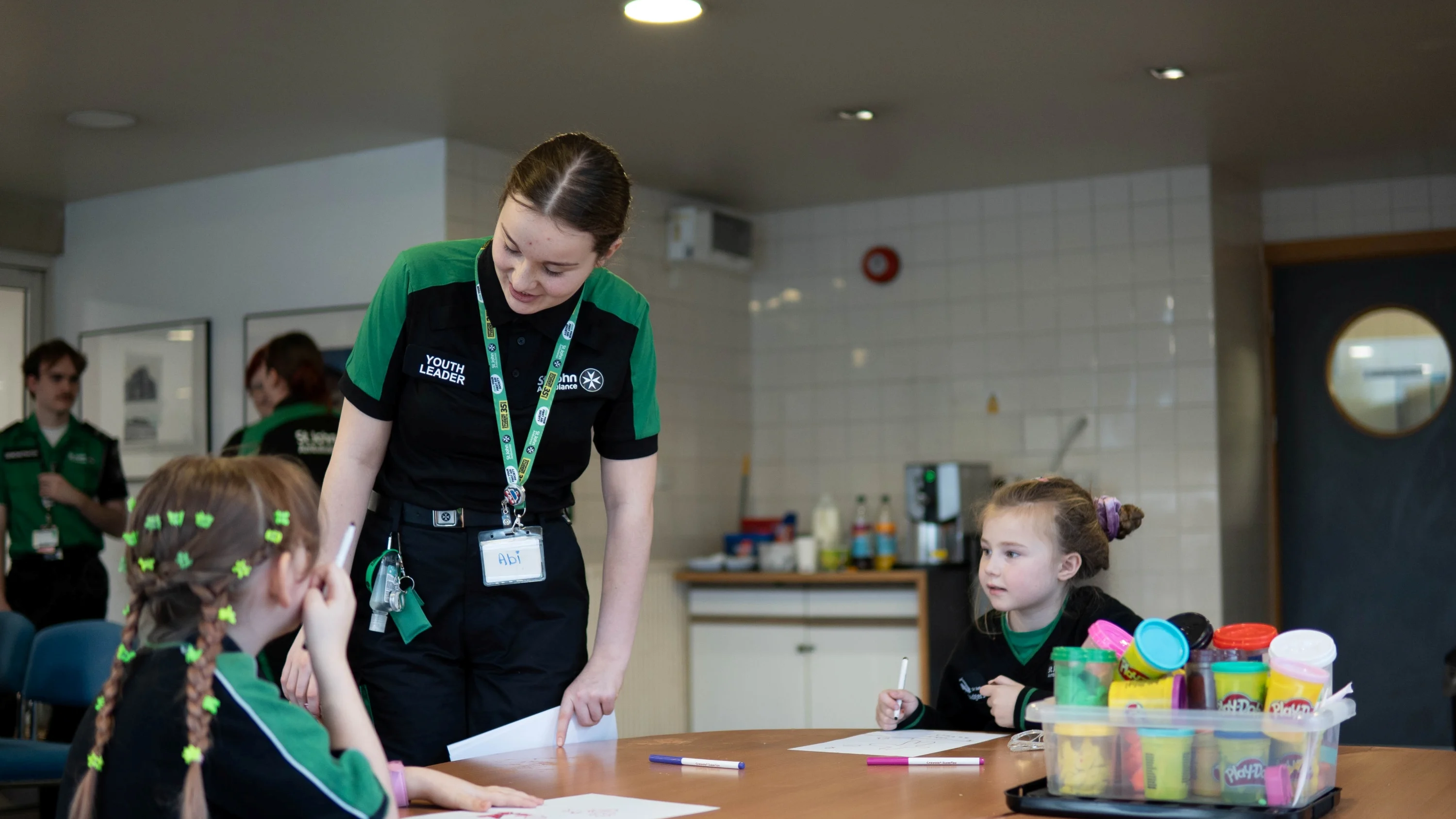 A St John Ambulance youth leader working with children.