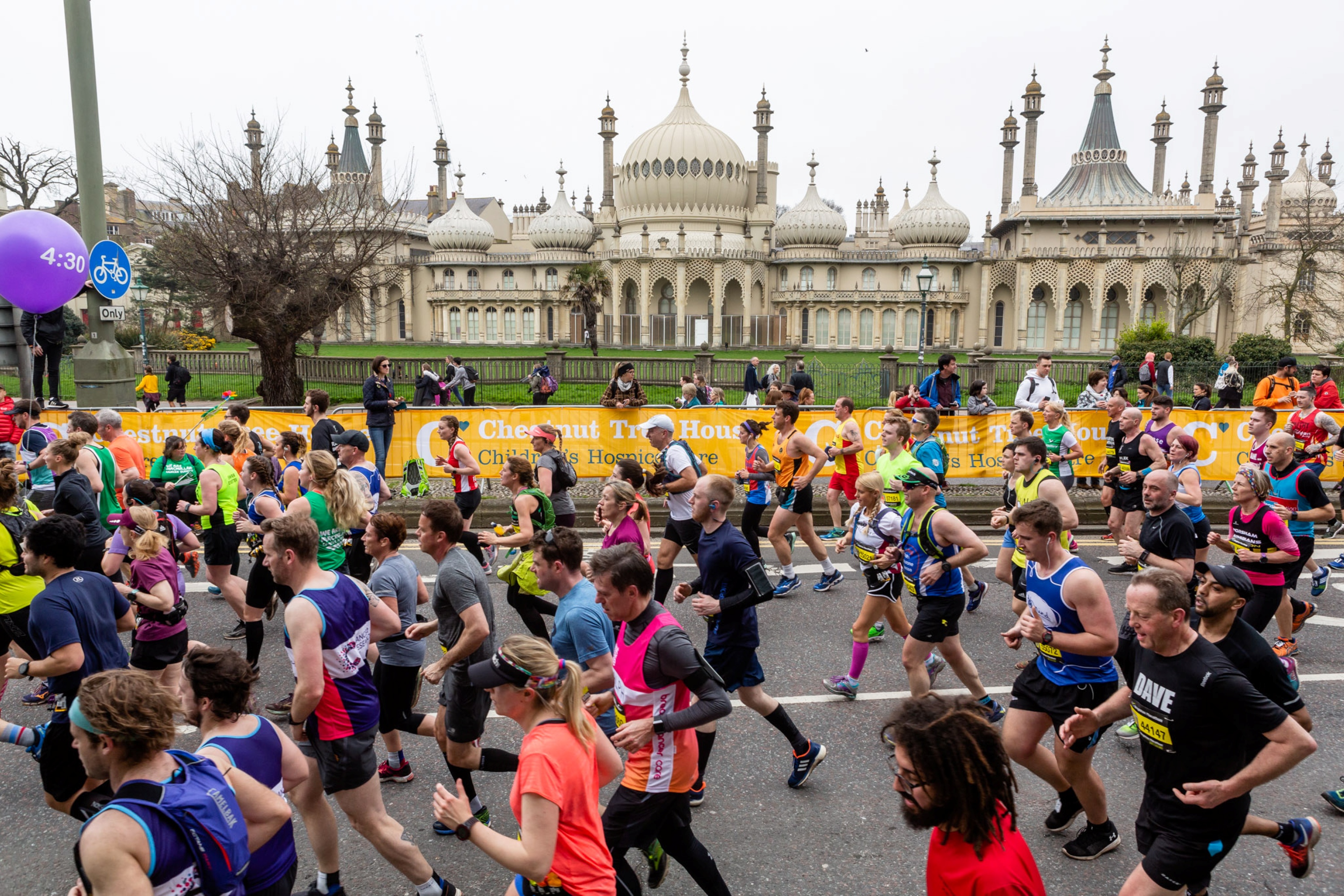 Brighton Marathon runners on the road running past the Royal Pavilion.
