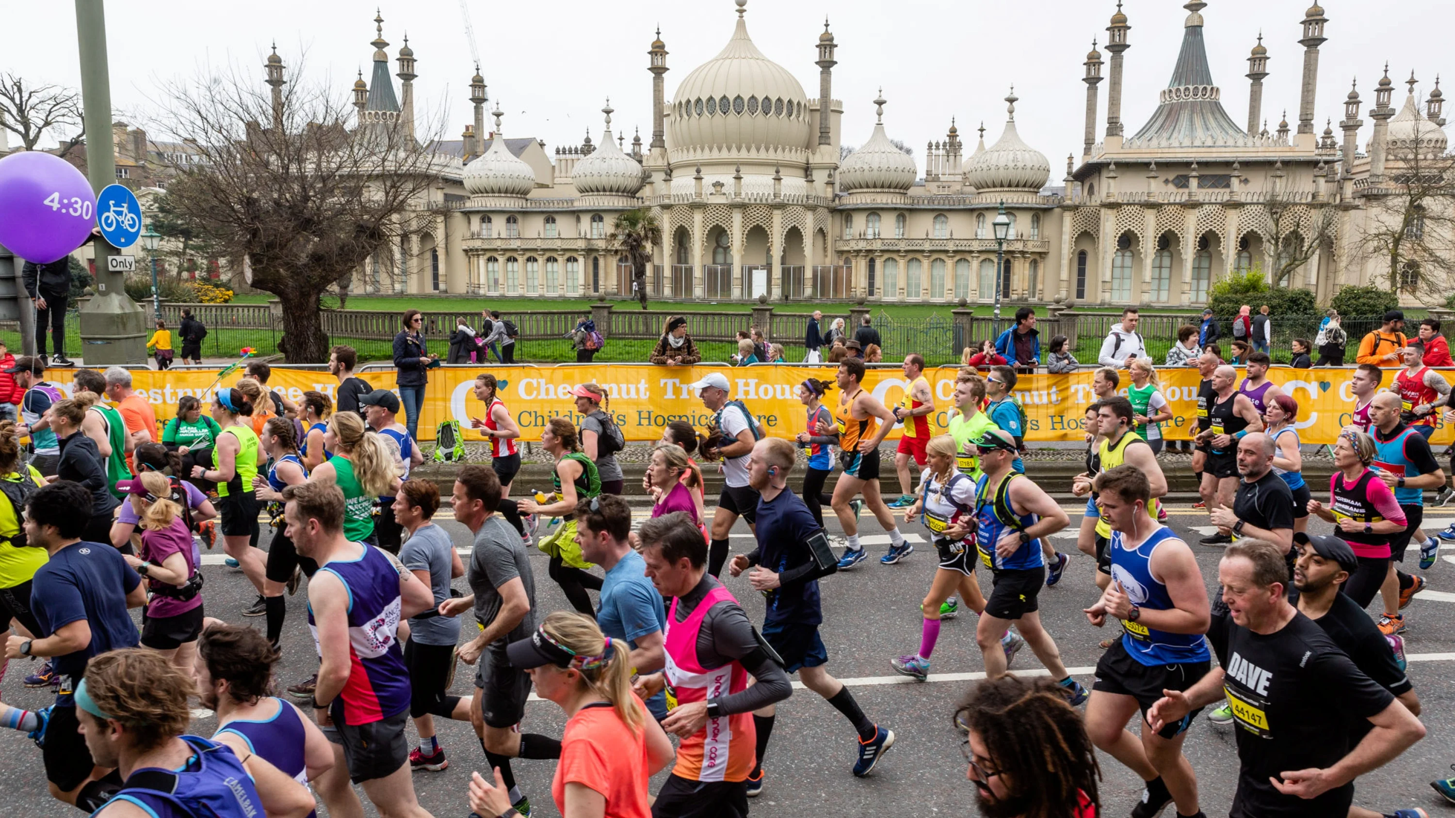 Brighton Marathon runners on the road running past the Royal Pavilion.
