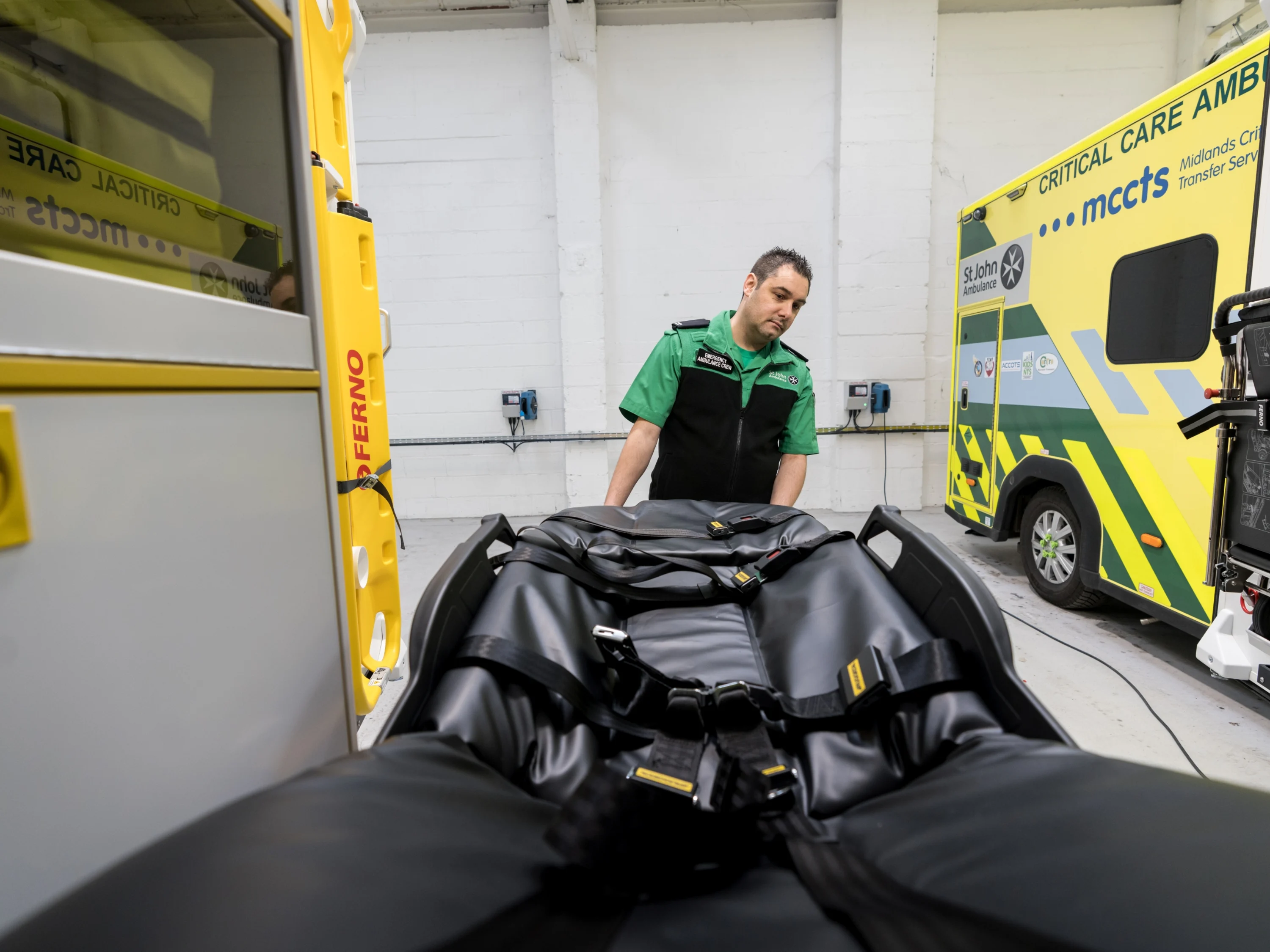 A St John Ambulance worker removing a gurney from the back of one of our emergency ambulances.
