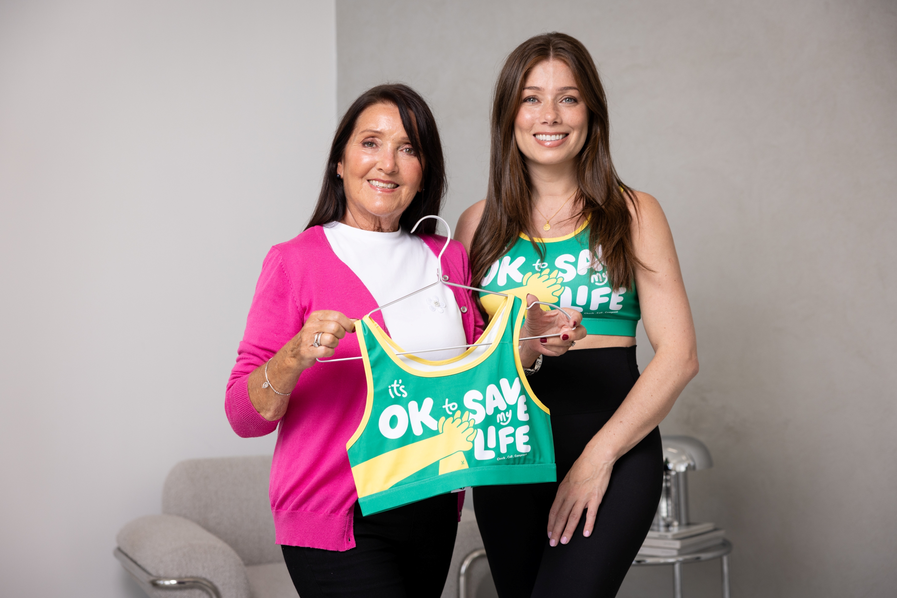 Nikki Sanderson wearing a CPR Bra and stood next to her mum who is holding a CPR Bra on a coat hanger. 