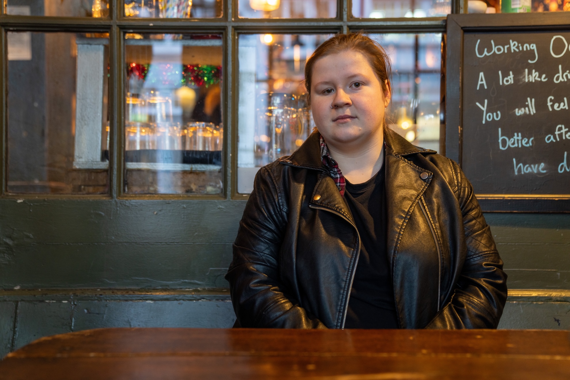 A photograph of Eve sitting at an outdoor table at a pub.