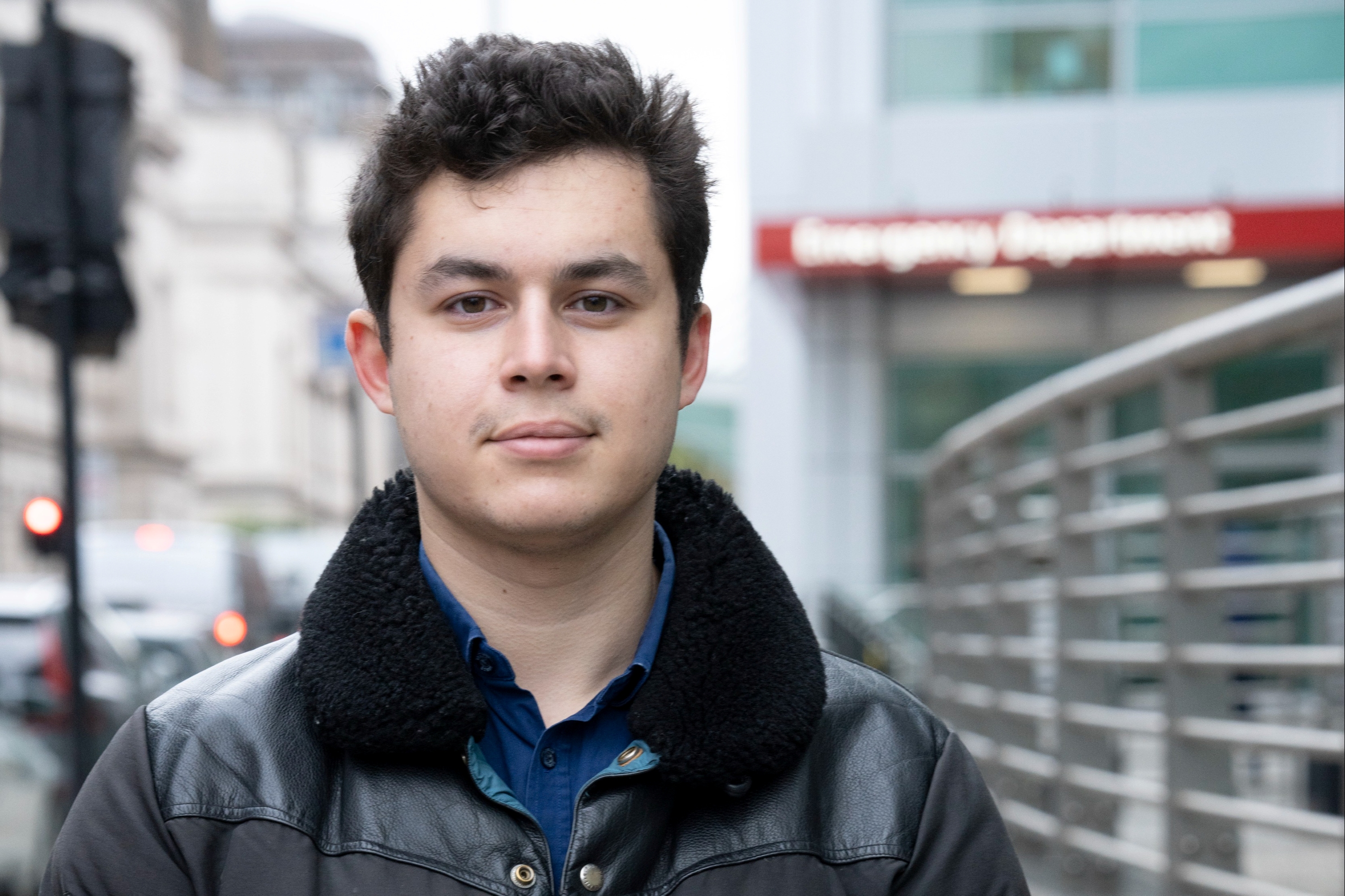 A photograph of Caspar standing in the street, with his hands clasped in front of him.